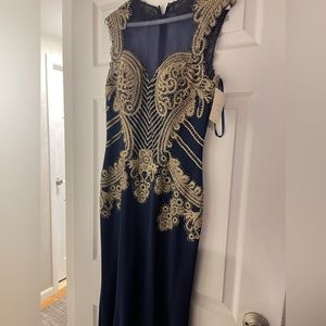 Gown, navy blue with beautiful embroidery. Size 8, never worn with tags